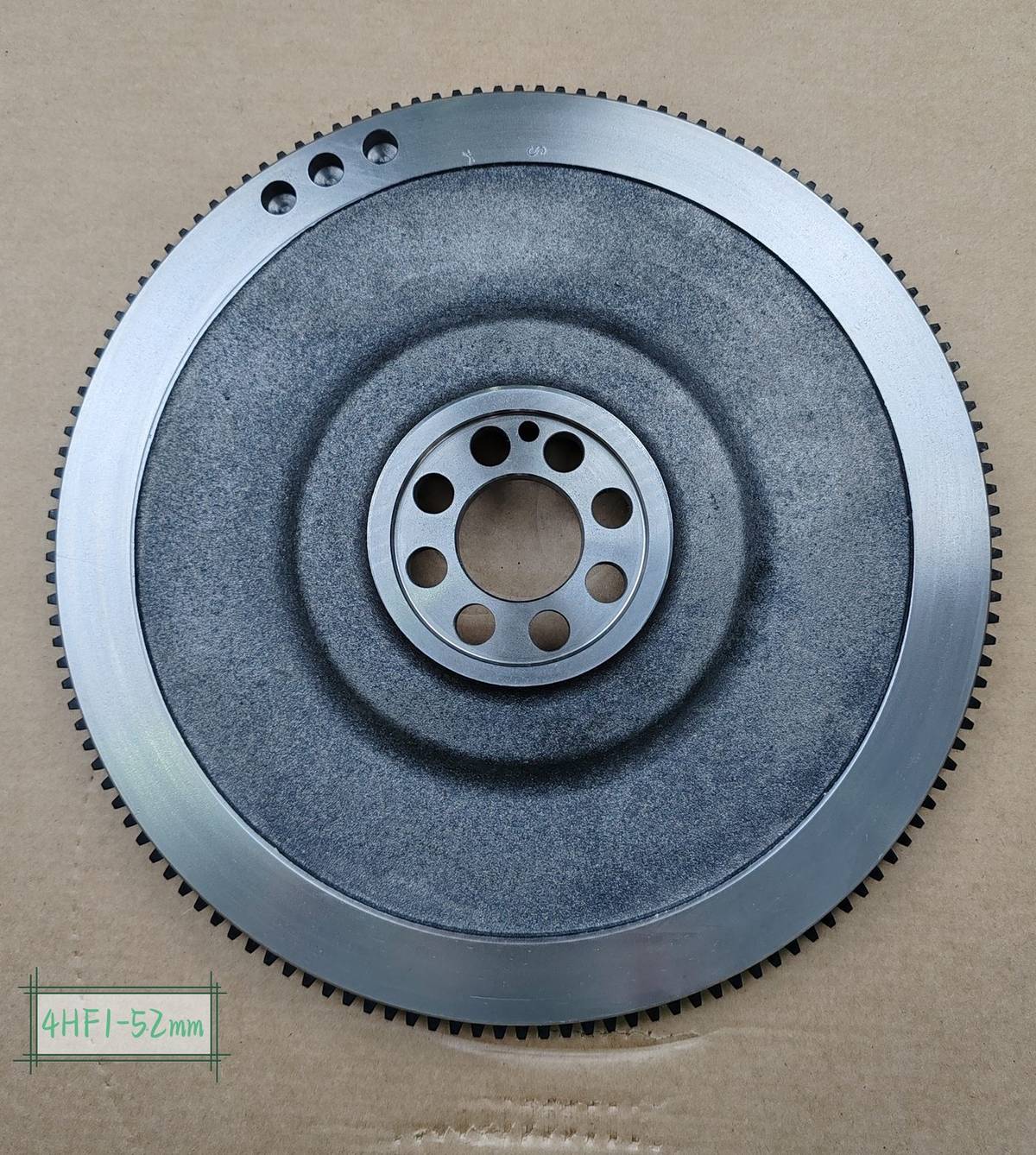 ISUZU 4HF1 flywheel 52 mm version, front face with four clustered holes near the rim