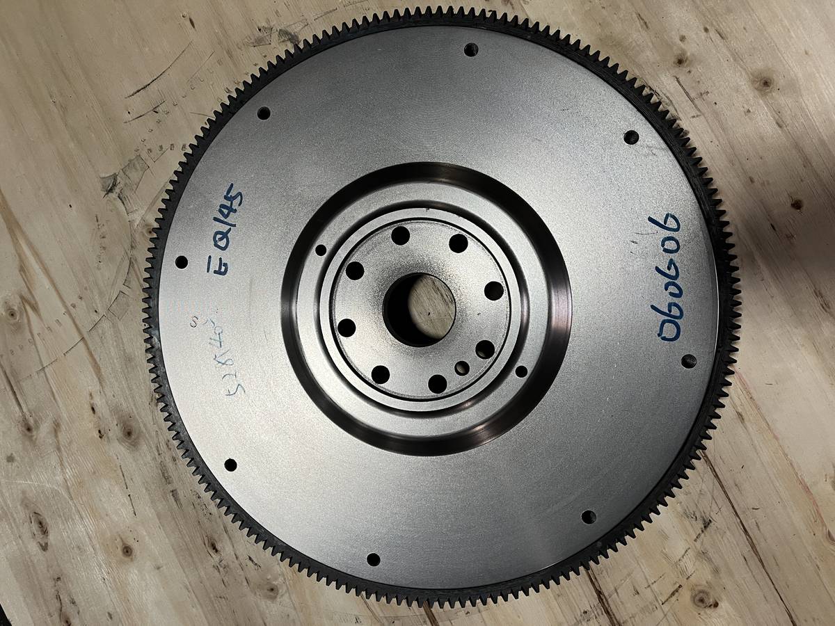 Cummins EQ145 flywheel, front face, wide flat friction face with crank flange bolt circle and additional clutch mounting holes near the rim