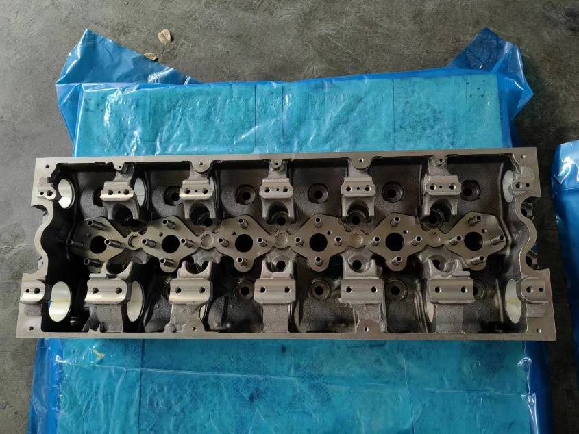 Cummins K-series cylinder head top deck showing rocker pedestals and injector bores