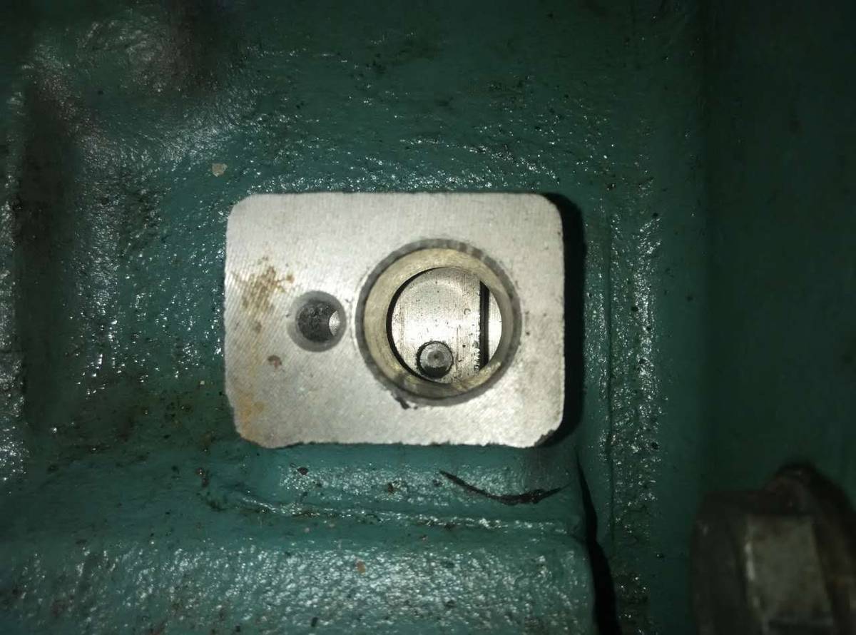 Machined sensor pad on a flywheel housing with the sensor bore