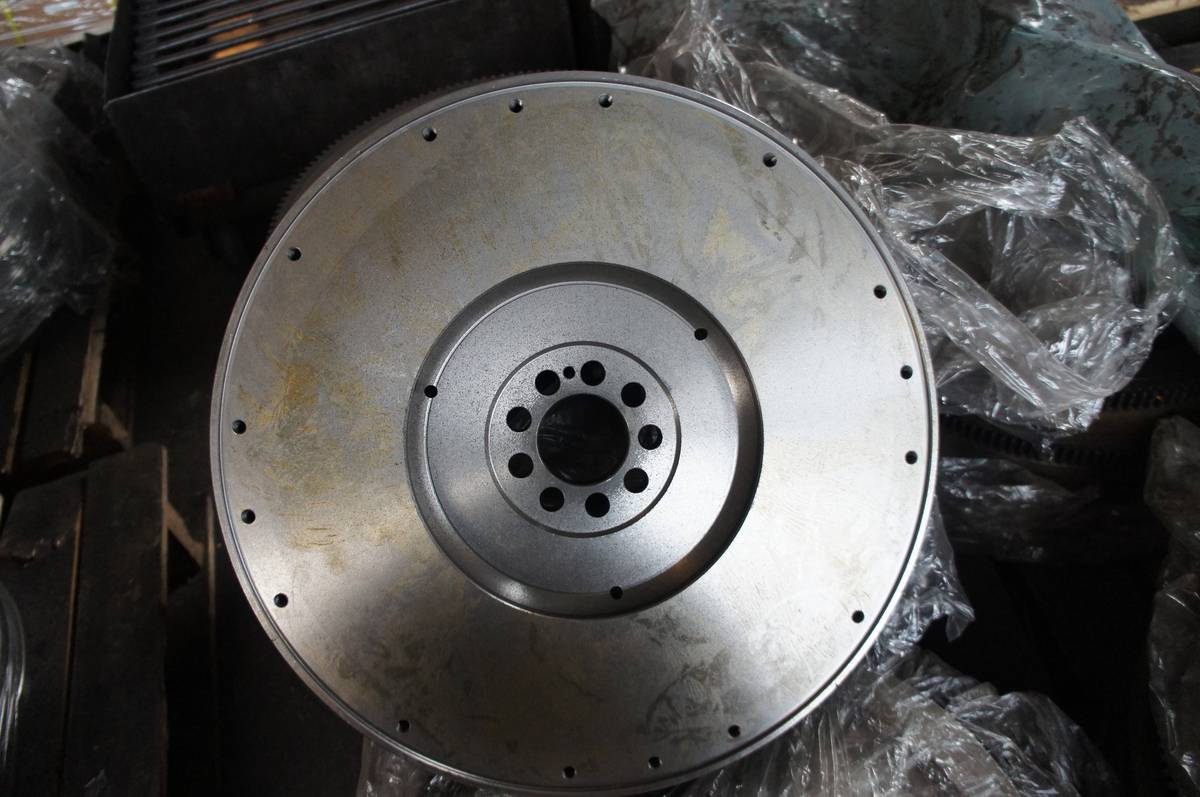 HINO P11C flywheel in the standard flat form, flat topped clutch face with pressure plate bolt ring and machined hub