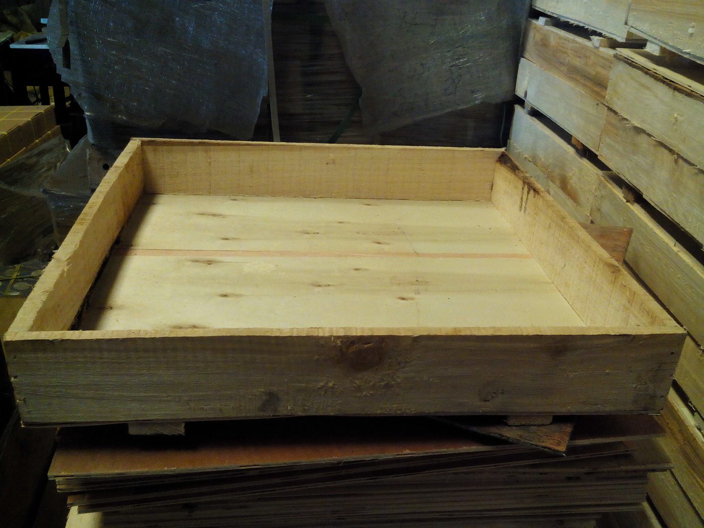 Interior of a plywood export case showing the timber frame and skid base that carry the load