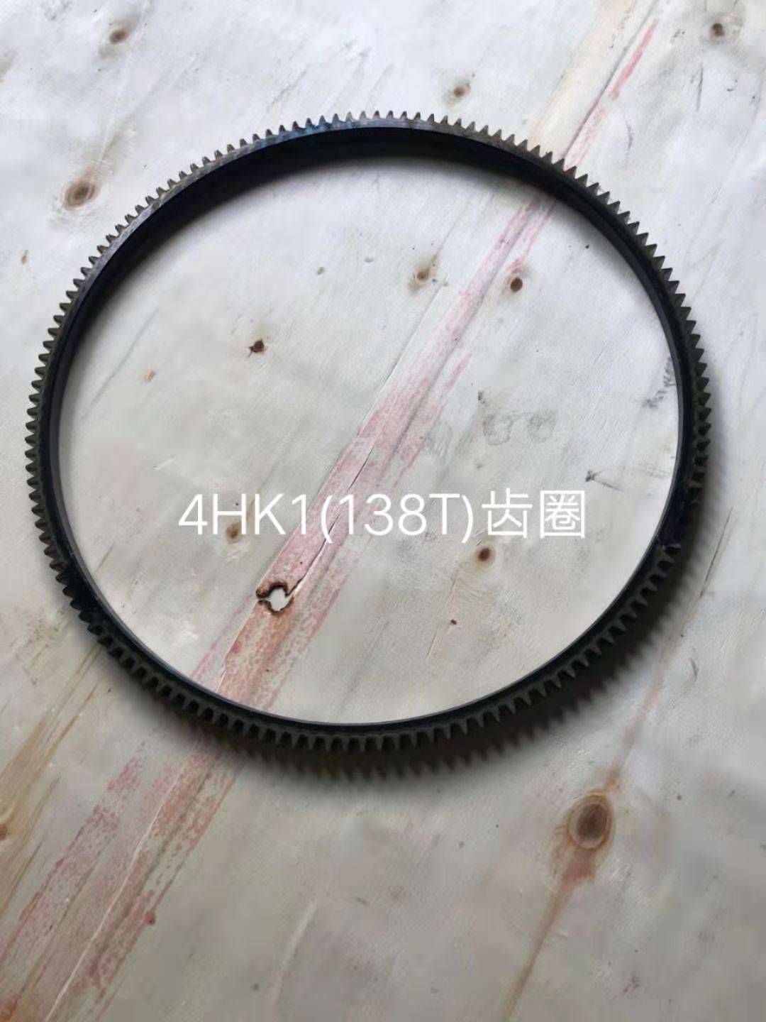 ISUZU 4HK1 starter ring gear, 138 teeth, photographed flat showing the full tooth ring