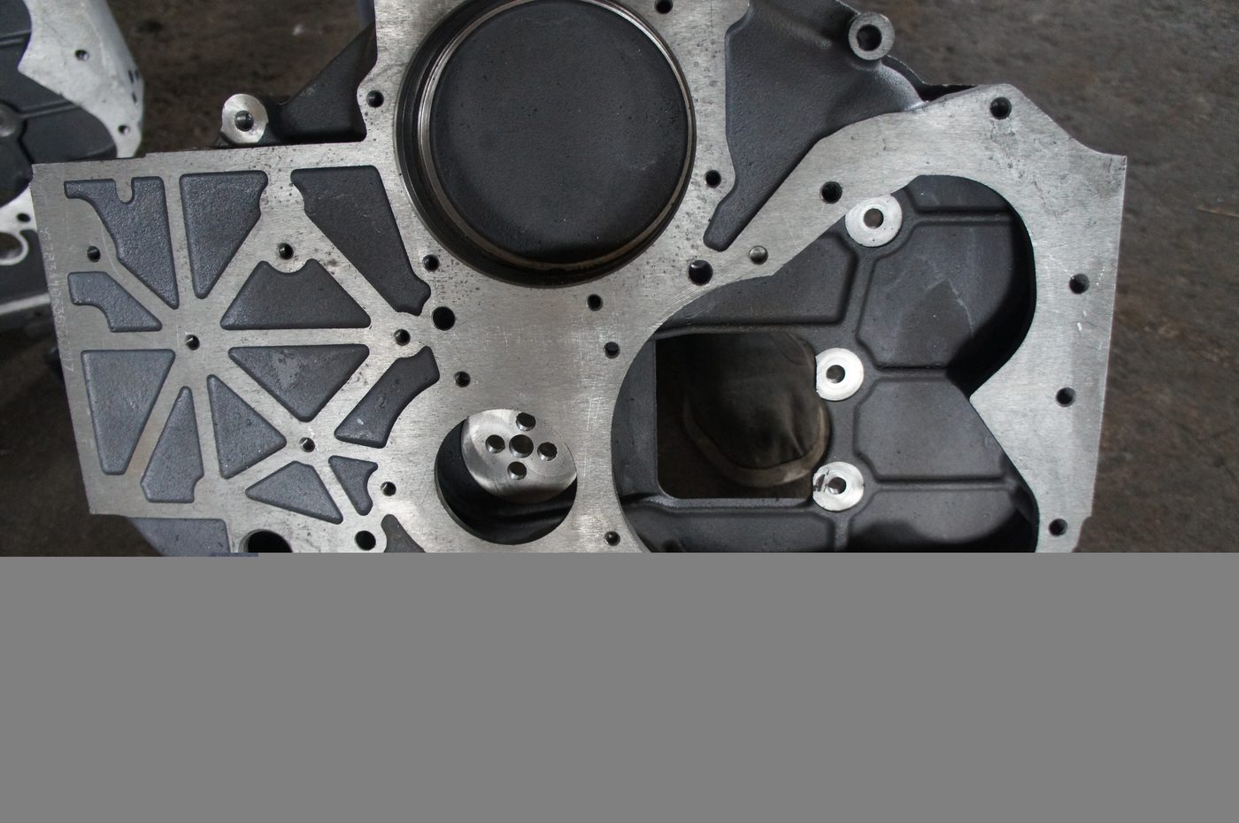 Timing alignment marks cast on the outer face of the housing, used to synchronize crank and cam during fitting